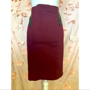 Bebe brand. Form fitting skirt, spandex material. Purple and black.